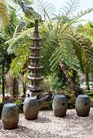 Seats in Oriental garden at Monte Palace Tropical Garden, Madeira, with Japanese pagoda and tree ferns