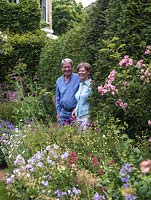 Jenny and Richard Raworth between herbaceous beds in their lovely summer garden.