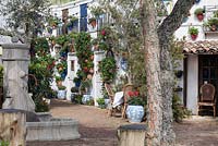An Andalusian Moment, Best Show Garden, Malvern Spring Gardening Show 2015, depicting an Andalusian village with hidden courtyards, colourful pelargoniums in pots on the white washed walls
