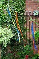 Ribbons tied to a tree branch to decorate a garden