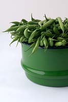 French beans in green enamel colander