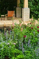 The M and G Garden - The Retreat. Contemporary wooden terrace and seat with planting combination of Rosa, Verbascum 'Cotswold Beauty', Nepeta 'Walker's Low', Amsonia tabernaemontana. 