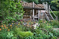 A Trugmaker's Garden. Traditional timber workshop and cottage garden plants. RHS Chelsea Flower Show, 2015