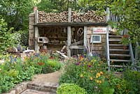 Trugmaker's traditional timber workshop and cottage garden plants. The Trugmaker's Garden - RHS Chelsea Flower Show 2015 