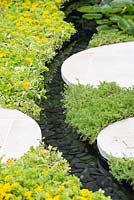 Water rill with sedum and chamomile lawn for birds, between circular paving - Living Landscapes: City Twitchers Garden, RHS Hampton Court Palace Flower Show 2015