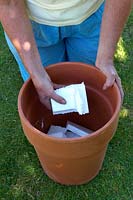 Fill bottom of terracotta container with pieces of polystyrene