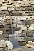 A spade lent against the wall.