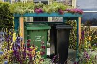 Front garden setting with mixed colourful planting including Verbascum olympicum and living roof wheelie bin shelter by Front Yard Company - Community Street - RHS Hampton Court Flower Show 2015