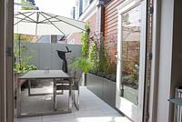 Balcony with seating area and modern silver containers