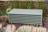 Jacksons Secret Garden Party. A wooden bench conceals a water storage tank. Designer: Jon Sims.