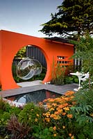 Creations Mid Century Modern - Best Low Cost High Impact Garden. RHS Hampton Court 2013. Orange moongate wall divider with pool. Design: Adele Ford and Susan Willmott Sponsor: Outdoor Creations
