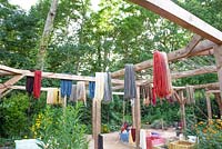 Garden used as work place for dyeing with plants. Wool hanging to dry.