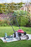 Tools required for performing a full maintenance on your lawnmower. Wax coated sheet, multi purpose oil, lawnmower oil, tray, brush, trowel, sharpening stone, socket and spanner set , spark plugs, air filter and a nut wrench