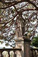 Statue on ballustrade overlooking the Olive Grove. Villa Gamberaia, Settignano, nr Florence, Tuscany, Italy. September. 
