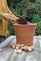 Filling container with compost