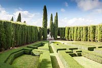 The Lower Garden. Box hedges backed by Cupressus sempervirens. Pool and statue. Villa La Foce, near Chianciano Terme, Siena, Tuscany, Italy. October. 