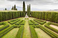 The Lower Garden. Box hedges backed by Cupressus sempervirens. Pool and statue. Villa La Foce, near Chianciano Terme, Siena, Tuscany, Italy. October.