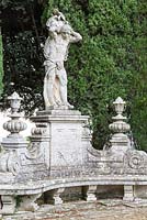 Statue and seat in the Lower Garden, Villa La Foce, near Chianciano Terme, Siena, Tuscany, Italy. October. 