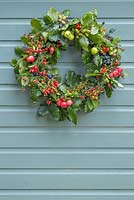 An Autumnal Berry wreath featuring Wild Crab Apples, Hawthorn - Crataegus, Sloe berries - Prunus spinosa, Rose hips, English Oak -Quercus robur and Crocosmia seed heads