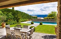View from pool house to lawn and swimming pool. Luberon, France. 