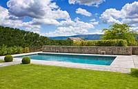 Lawn and path to swimming pool with Luberon hills behind. 