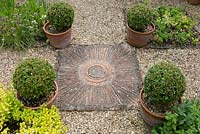 Salterns Cottage, a private garden on the Isle of Wight. Paving with circular pattern.
