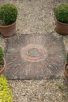 Paving with circular pattern. Salterns Cottage, a private garden on the Isle of Wight. 