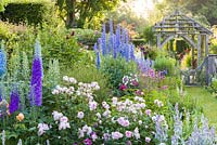 Shortly after dawn on a misty morning in the Sundial Garden at Wollerton Old Hall Garden, Wollerton, Shropshire - featuring David Austin roses, Stachys, Delphiniums, Dahlias, Phlox paniculata, Salvia microphylla and Knautia, among a wide range of other herbaceous plants.