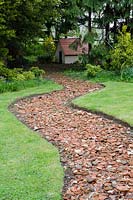 Recycled tile path leading towards the Clarice Cliff Garden