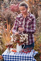 Creating a Floral display with dried perennial flowers in November: rosehips, honesty, Sedum, Aster, Persicaria