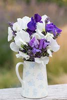 Sweet peas arranged with sprigs of English lavender.