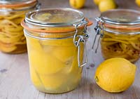 A jar of preserved lemon in juice and salt.