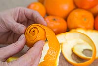 Wrap the orange peel around itself to create a flower shaped head