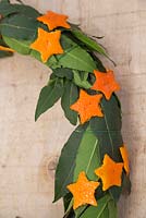 Detail of scented wreath made with Laurel leaves and small Orange stars