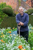 Fergus Garrett, head gardener at Great Dixter, standing in the stock beds planted for spring with tulips, honesty, forget-me-nots, cow parsley and poppies.