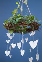 Clay hearts featuring impressions from conifer foliage, hanging from an Ivy covered wreath