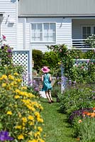 Girl running through English cottage style garden