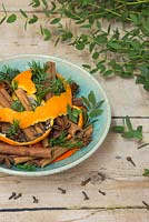 A scented bowl featuring Orange peel, sprigs of Eucalyptus, sprigs of Pinus, Cinnamon sticks, Cloves and Star anise