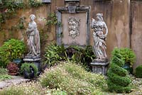 Italianate statues with Fleabane - Erigeron karvinskianus and box topiary, September