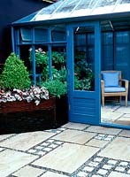 Outside of blue painted conservatory - raised planter with buxus sempervirens, cone and heuchera 'Pewter Moon'. CFS, 2003
