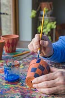 Paint the pots in a chequered formation to recreate the tartan pattern