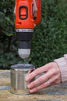 Drilling water drainage holes in an Aluminium can