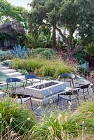 View of gas fired fire pit and outside seating. Debora Carl's garden, Encinitas, California, USA. 