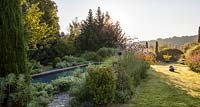 Formal pool surrounded by Euphorbia, box balls, Verbena bonariensis, Miscanthus and perennials - July, Les Jardins de la Poterie Hillen
