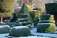 Topiary shapes with a dusting of snow at Levens Hall and Topiary Garden, Cumbria, UK