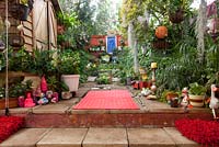Inner city garden with spanish moss, ferns and palms features colourful eclectic retro pieces sourced from local markets. 