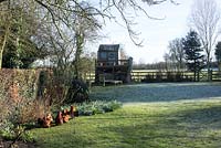 Chickens - Pekin bantams on a frosty morning with child's play house on raised platform. St Francis Cottage