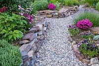 Retaining dry stone walls. Borders with Dianthus, Aster, Lavandula and Viola 
