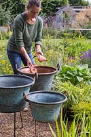 Add crocks to the vintage copper planters to assist with drainage