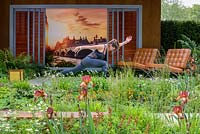 A yoga practitioner in Garden of Mindful Living with perennial planting including  Aquilegia 'White Barlow', Iris 'Kent Pride' and Geum 'Cooky'. The RHS Chelsea Flower Show 2016 - Designer: Paul Martin - Sponsor: Vestra Wealth LLP - GOLD